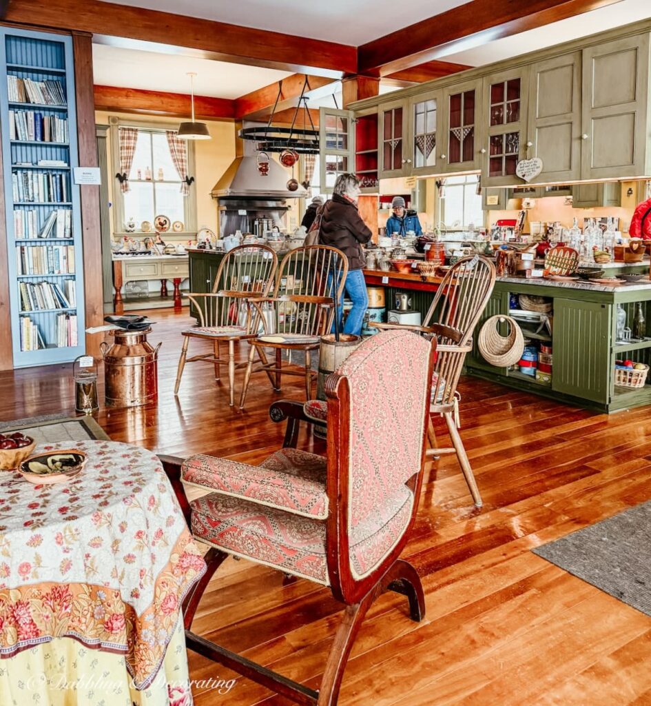 Luxury home estate sale in the kitchen with antique chairs and kitchenware displayed throughout and people shopping in how to shop estate sales.