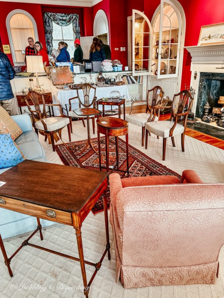 Inside the living room of a luxurious home's estate sale in Vermont filled with antiques.