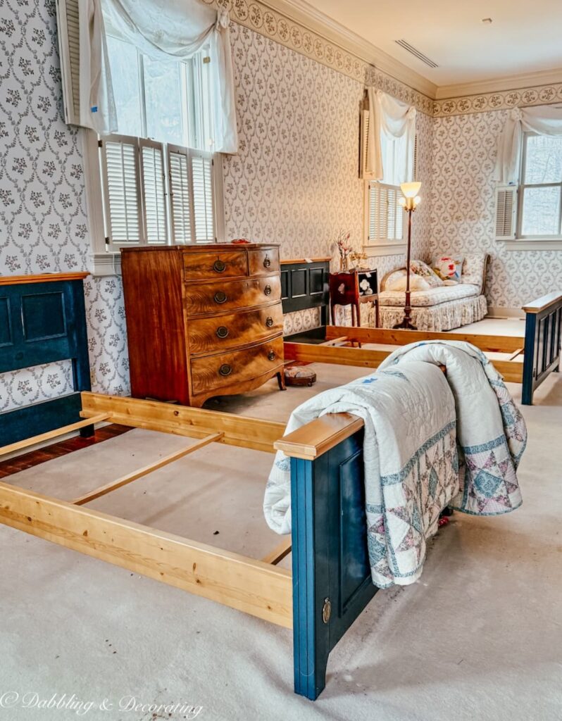 Children's bedroom with three beds, quilts, dresser in luxury estate sale home in Vermont.