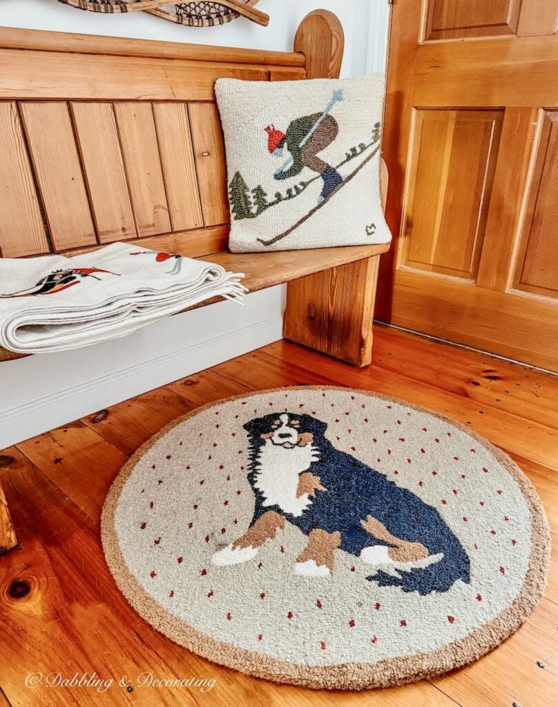 Vintage church pew bench entryway decorated with Berner rug, stitched winter white ski pillow and blanket by Chandler 4 Corner.