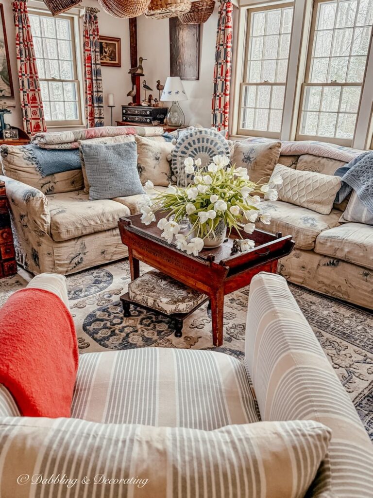 Sunday home trend style in a coastal Maine home's living room with collected antiques.