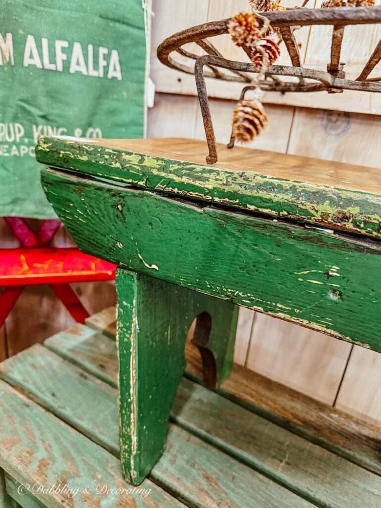 Vintage green bench in antique store for St. Patrick's Day decor ideas.