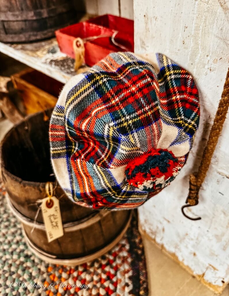 Irish red plaid hat with pom pom in antique store for St. Patrick's Day Decor Ideas.