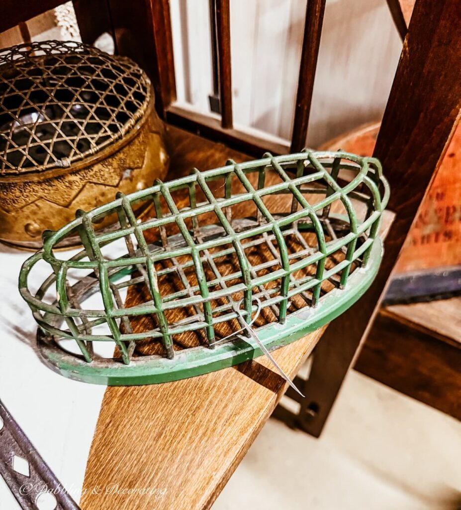 Vintage green floral frog in antique store for St. Patrick's Day decor ideas.