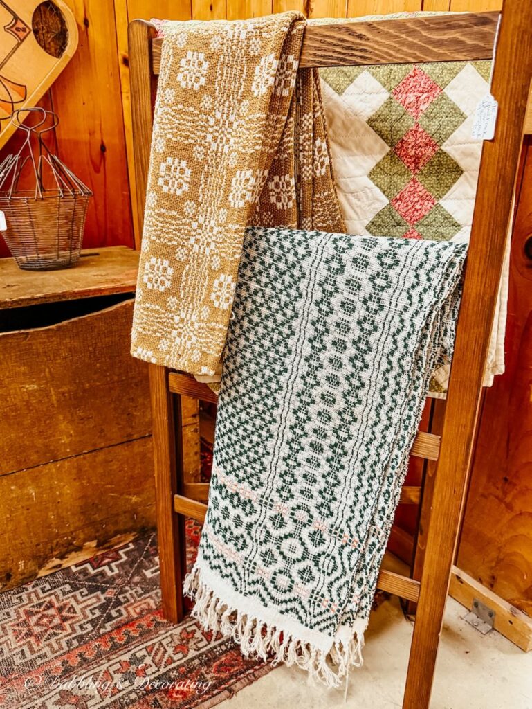 Rack of Irish quilts in antique store for St.Patrick's Day decor ideas.