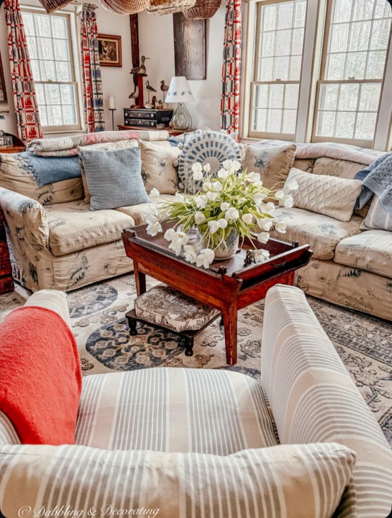 Sunday home trend style in a coastal Maine home's living room with collected antiques; decorating with family heirlooms.