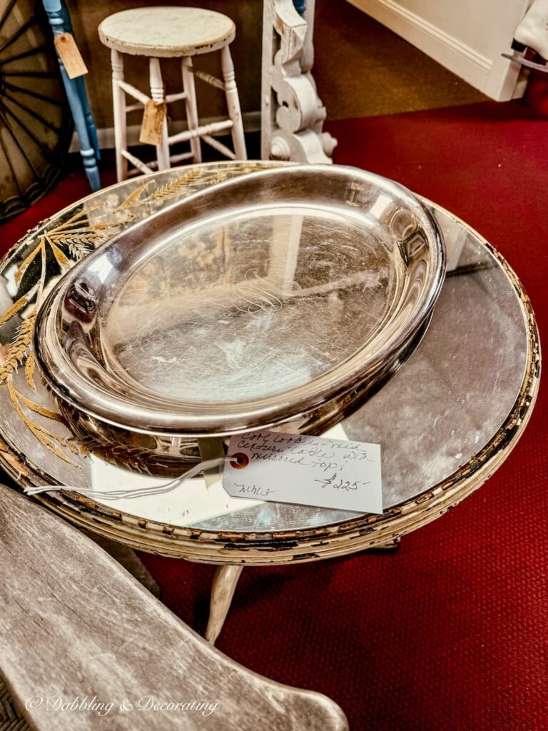 Grand hotel monogrammed silver tray on glass table antiquing in Saratoga Springs NY.