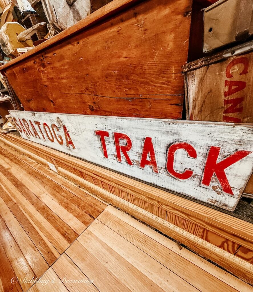 Saratoga Track sign in antique store antiquing in Saratoga Springs, NY.