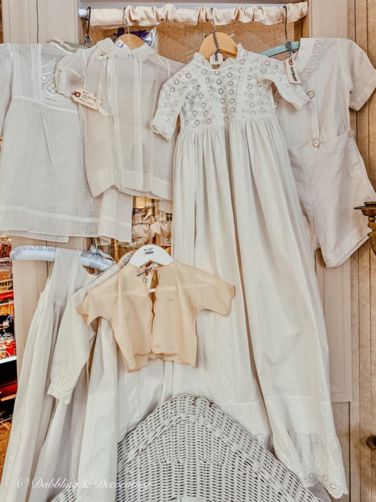 Display of antique white linen children's nightgowns antiquing in Saratoga Springs NY at Stone Soup antiques.