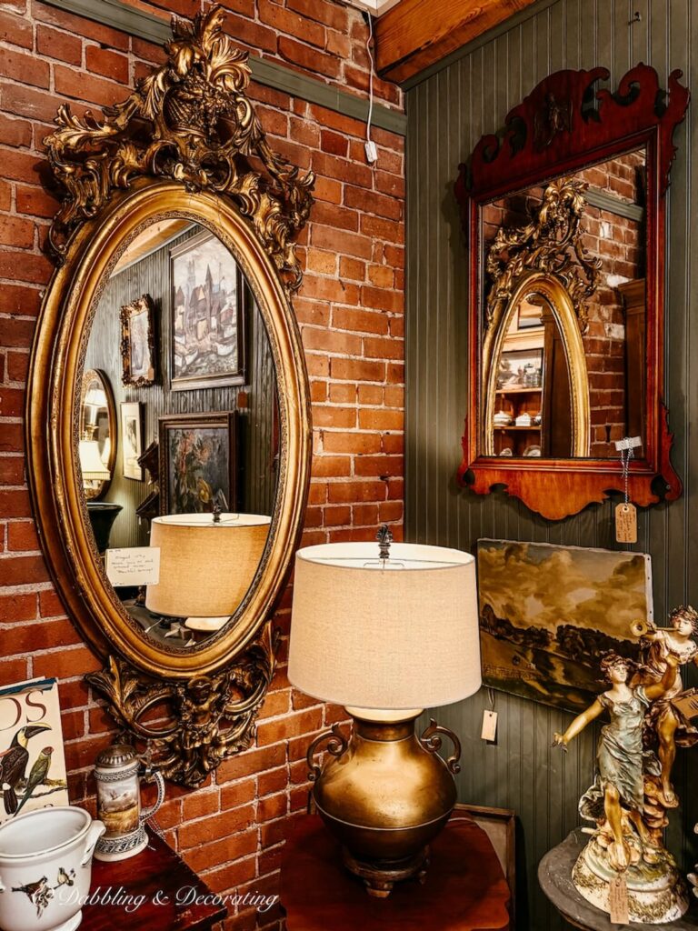 Large gold gilded mirror with other antiques inside Waverly Square Antiques Saratoga Springs, NY.