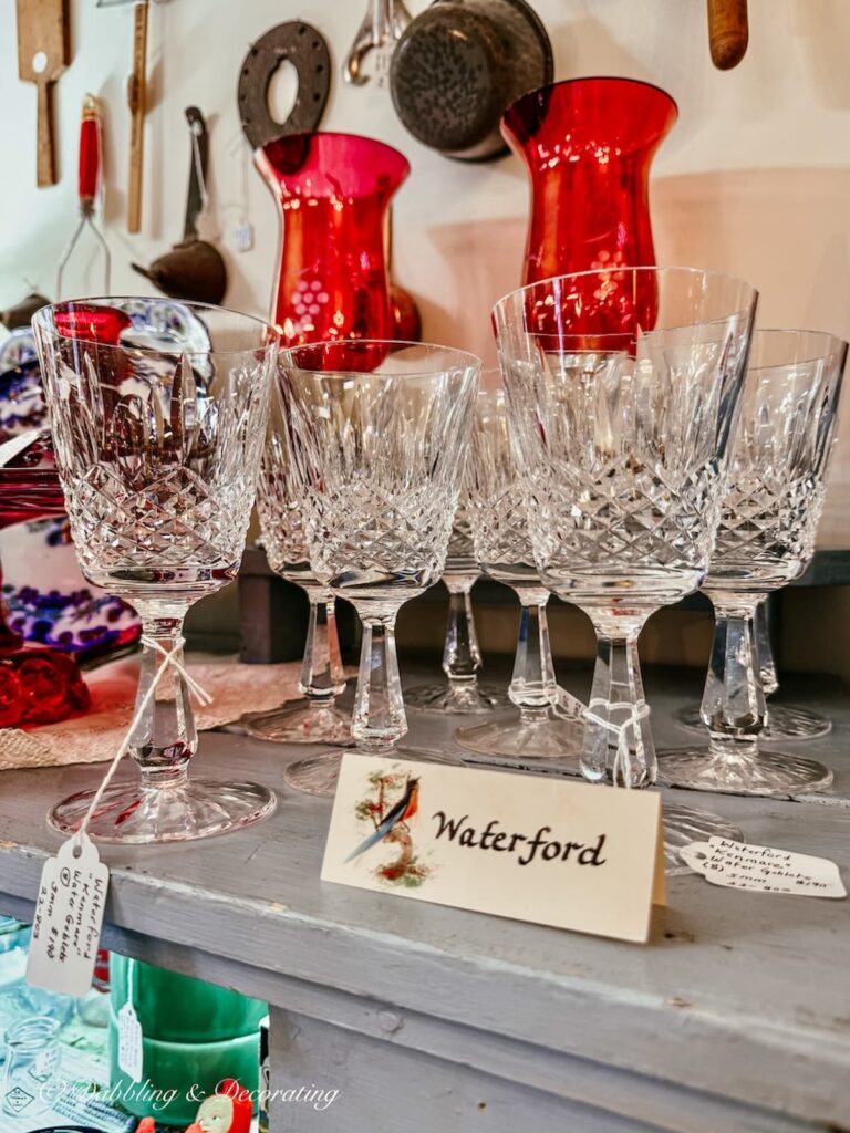 Collection of Waterford glasses in antique store for St. Patrick's Day decor ideas.