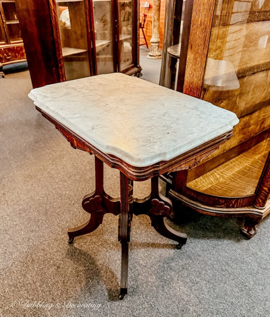 Gilded age side table with marble top antiquing in Saratoga Springs.