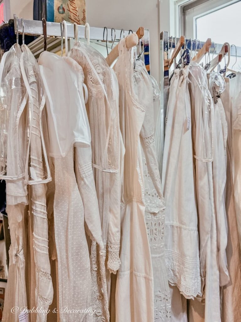 White linen women's vintage nightgowns hanging at Stone Soup's Antique store in Saratoga Springs, NY.