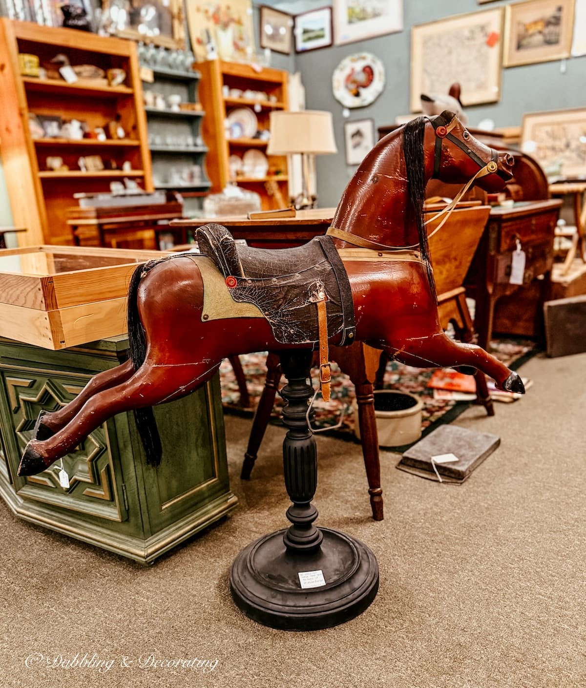 Antique wooden horse with saddle on stand in Waverly Square Antiques antiquing in Saratoga Springs, New York.
