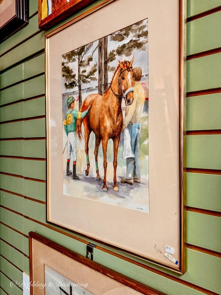 Race horse with jockey and trainer picture in antique store in Saratoga Springs, New York.