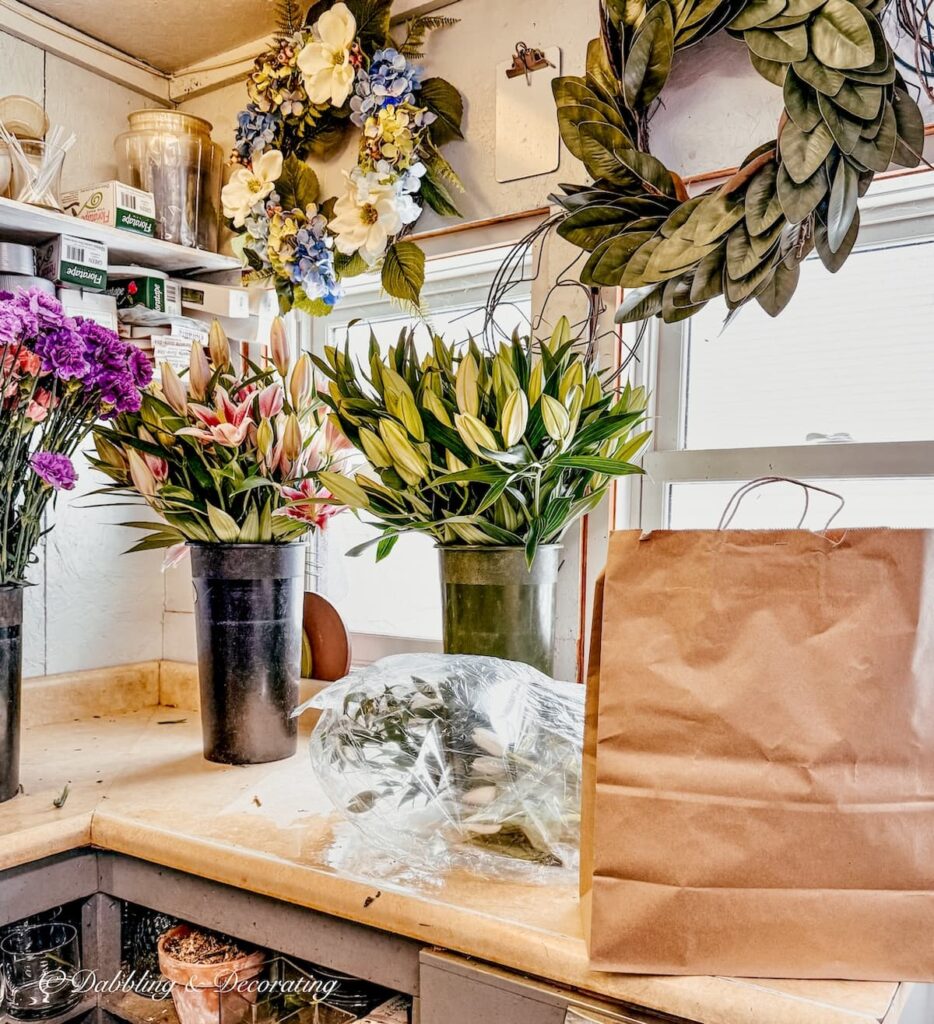 Inside a flower shop in Vermont with buckets of flowers on counter.
