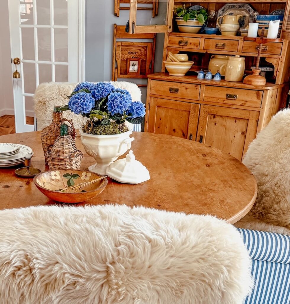 Vintage styled dining room with thrifted soup tureen planter ideas and blue hydrangeas.