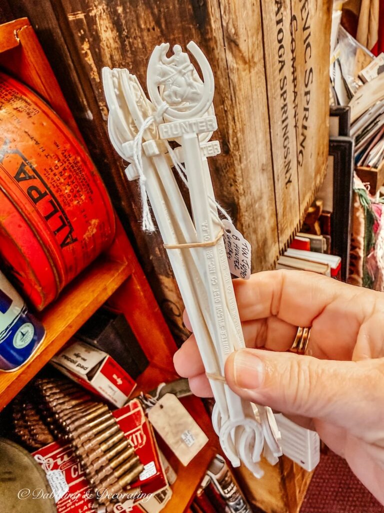 Set of white Hunger drink stirrers with Hunter written with horses in hand.