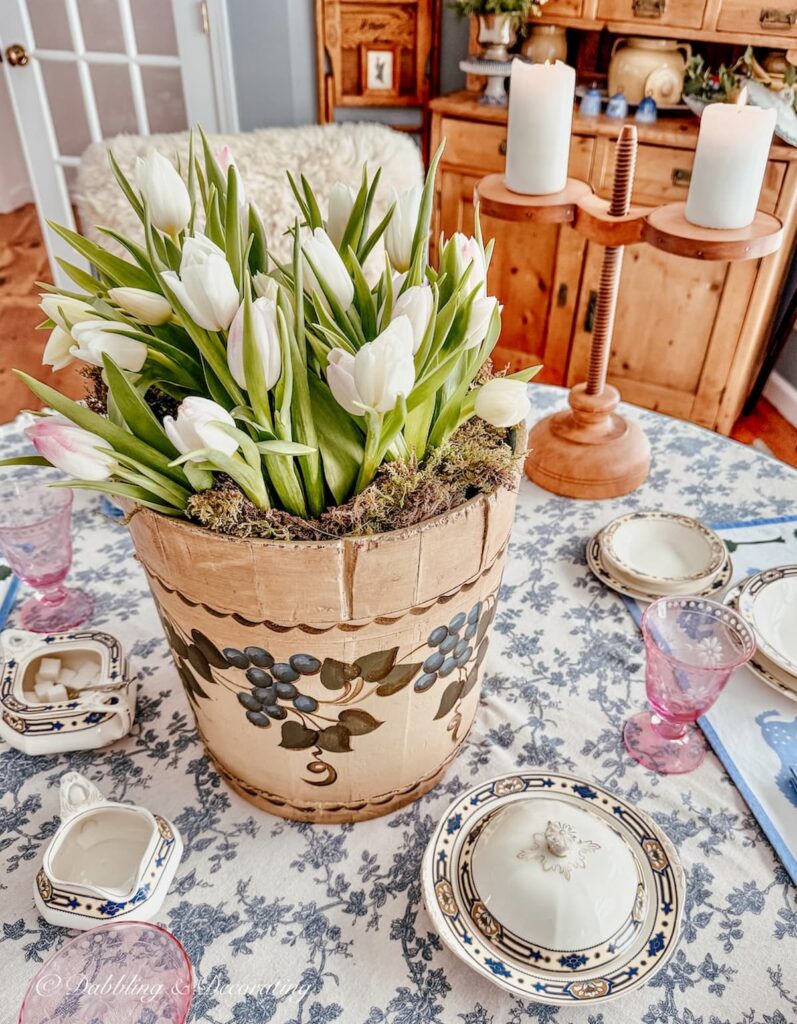 Vintage Wooden Bucket Flower Arrangement with white tulips on dining room table centerpiece.