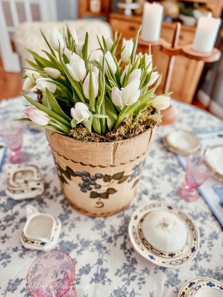 Vintage Wooden Bucket Flower Arrangement with a New England maple sap bucket painted with blueberries on table as centerpiece.