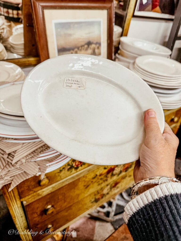 Miniature ironstone platter in hand at antique store.