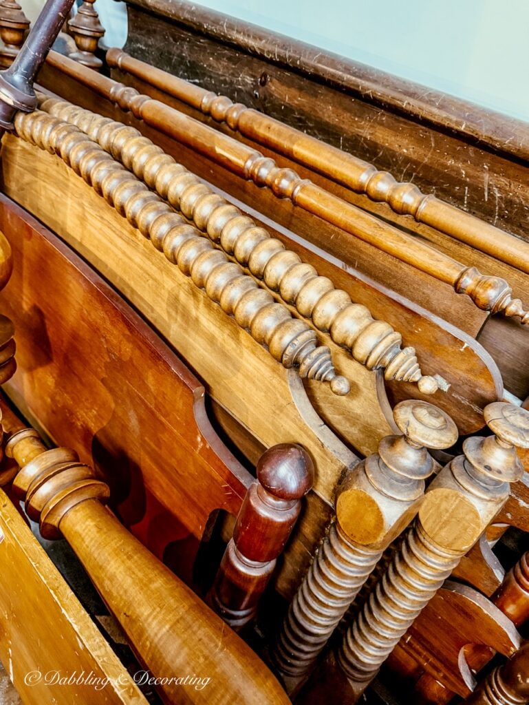 Stack of antique wooden beds on the second floor of Eagle Bridge Antiques in New York.