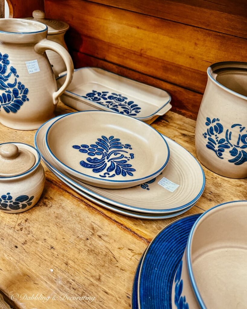 Blue and brown vintage pottery in hutch at Eagle Bridge Antique Center New York.