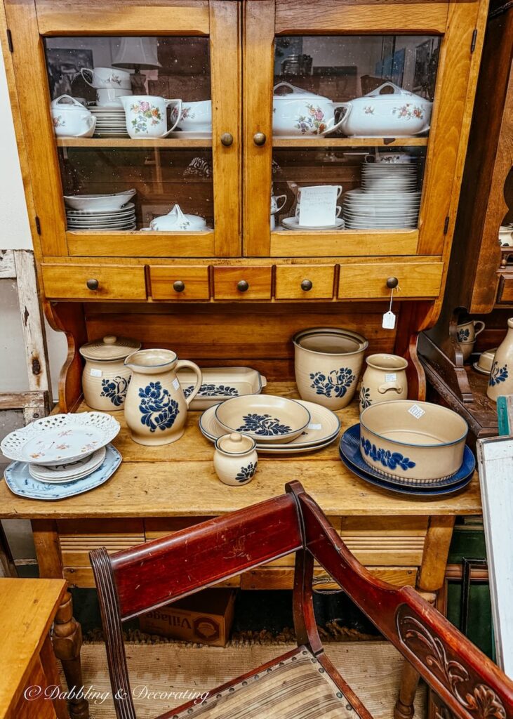 Cabinet filled with vintage dishes and Pfaltzgraff at Eagle Bridge Antiques.
