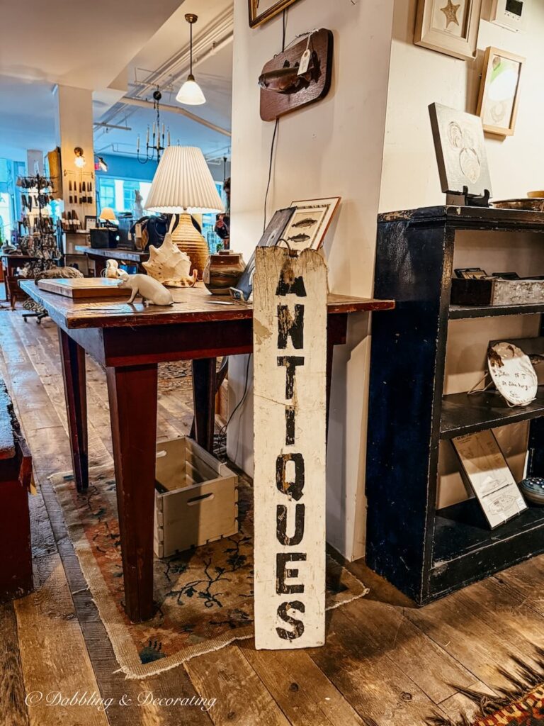 White sign with Antiques vertically displayed in antique store in Portland Maine. Flea For All
