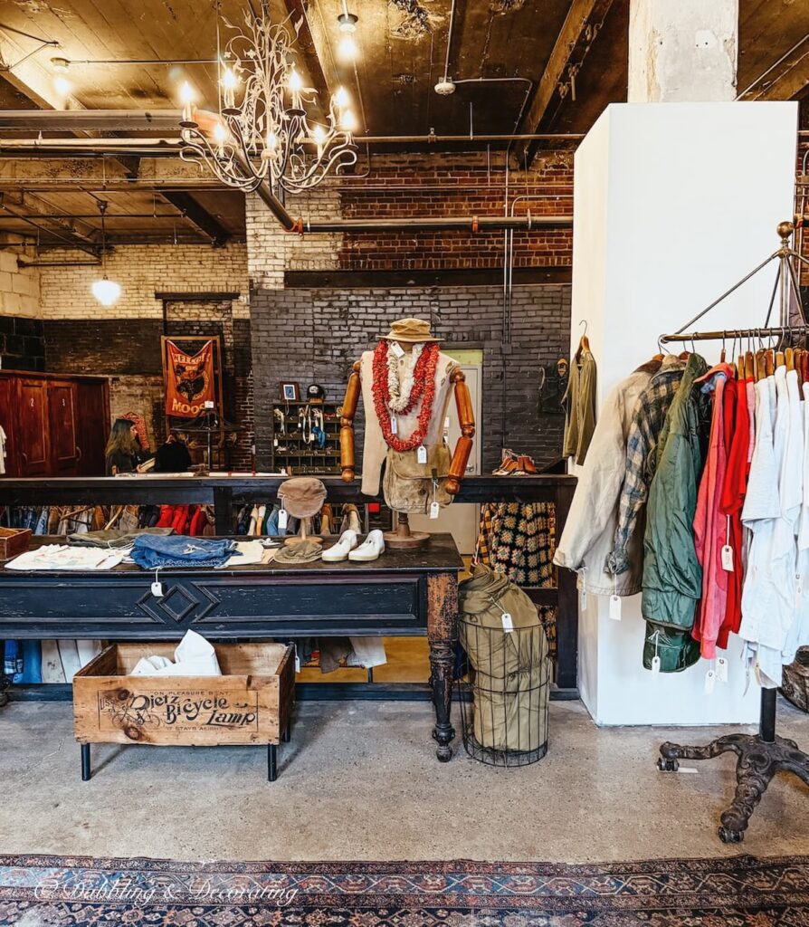 Inside Open House Portland, Maine in the thrifted vintage clothing section with racks, mannequins beautifully curated.