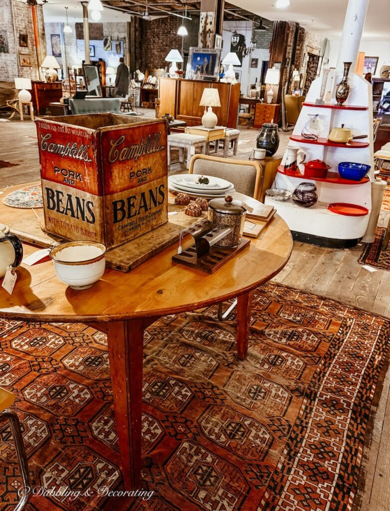 Inside Open House Portland formerly Flea-For-All with antique table and eclectic displays.