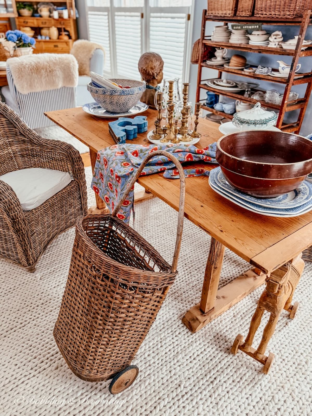 Open floor plan old dining room area with scattered furniture and decor items envisioning a old style kitchen workroom.