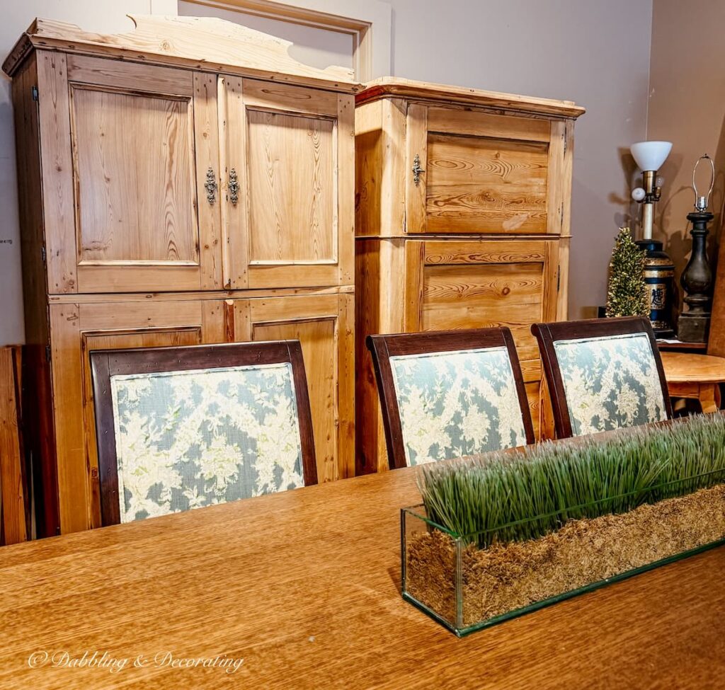 Two antique pine hutches in antique store while looking for a cabinet for a Scullery-Inspired Kitchen Workroom in an open floor plan.