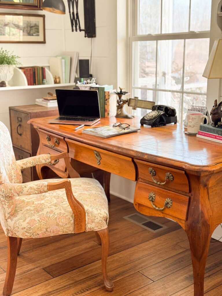Vintage antique desk with chair in home office.