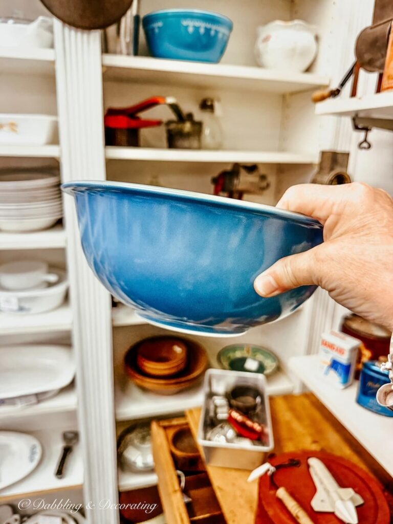 Vintage blue pyrex bowl in hand antiquing in Maryland.