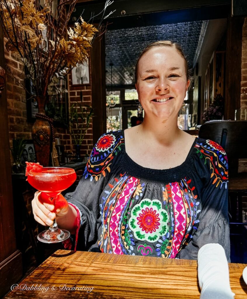 Woman holding a red cocktail in Zollies in New Castle Delaware.