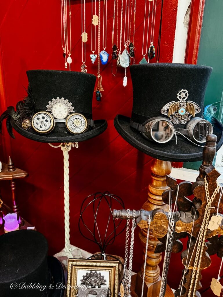 Two steampunk hats on hat displays antiquing in Maryland.