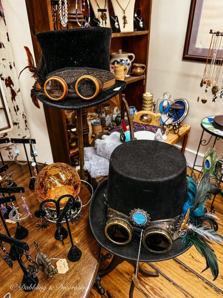 Two black steampunk hats antiquing in Maryland.