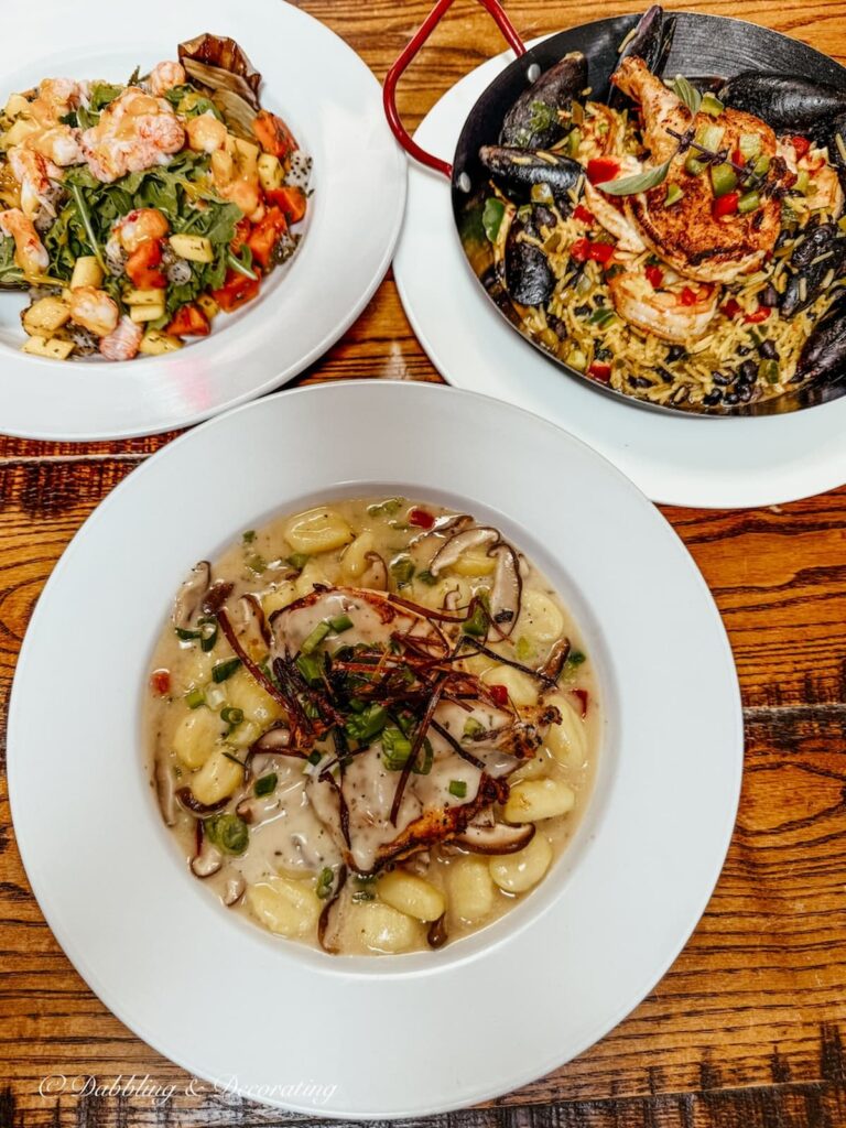 Three white dishes of delicious dishes at Zollies restaurant in New Castle Delaware.