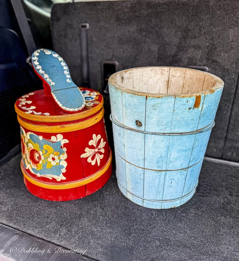 Red Scandinavian style shoe shine box with Nordic style and a blue wooden bucket in back of car after a solo antiquing date in Vermont.