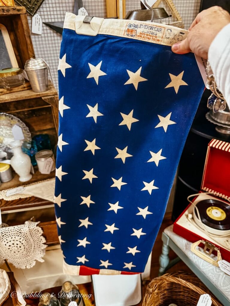 Vintage American flag bunting in hand at antique store in Amish country, Lancaster, PA.