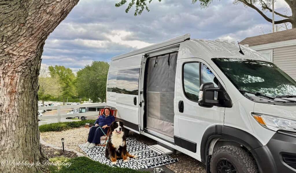 White Panoramic RV in campsite in Amish country Pennsylvania with Ann, home decor blogger and Bernese Mountain Dog, Ella.