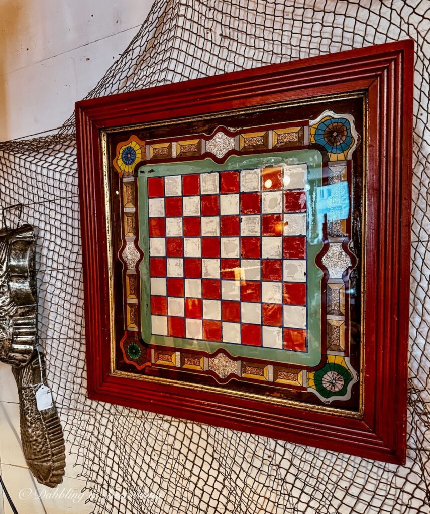 Antique chess board hanging on the wall inside a New England antique store.
