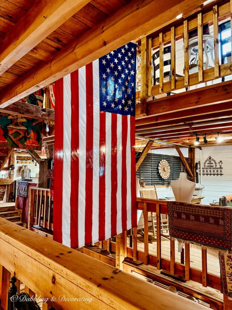 USA Flag hanging from ceiling inside the York Antiques Gallery in Maine.