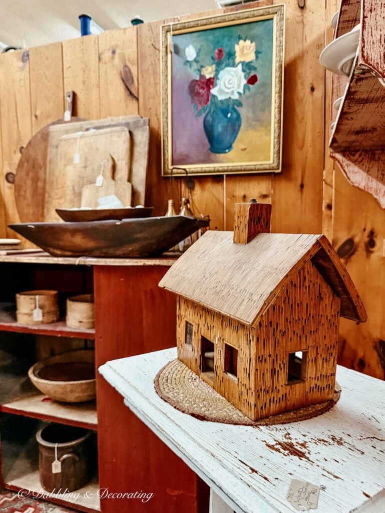 Small wooden house on table, looks handmade for a stylish Americana accent.