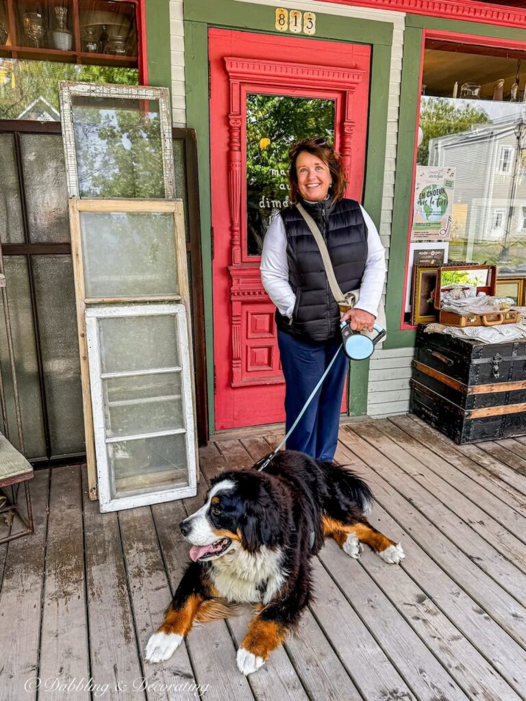 Ann, vintage home decor blogger outside an antique store in Bromont Quebec with Bernese Mountain Dog, Ella.