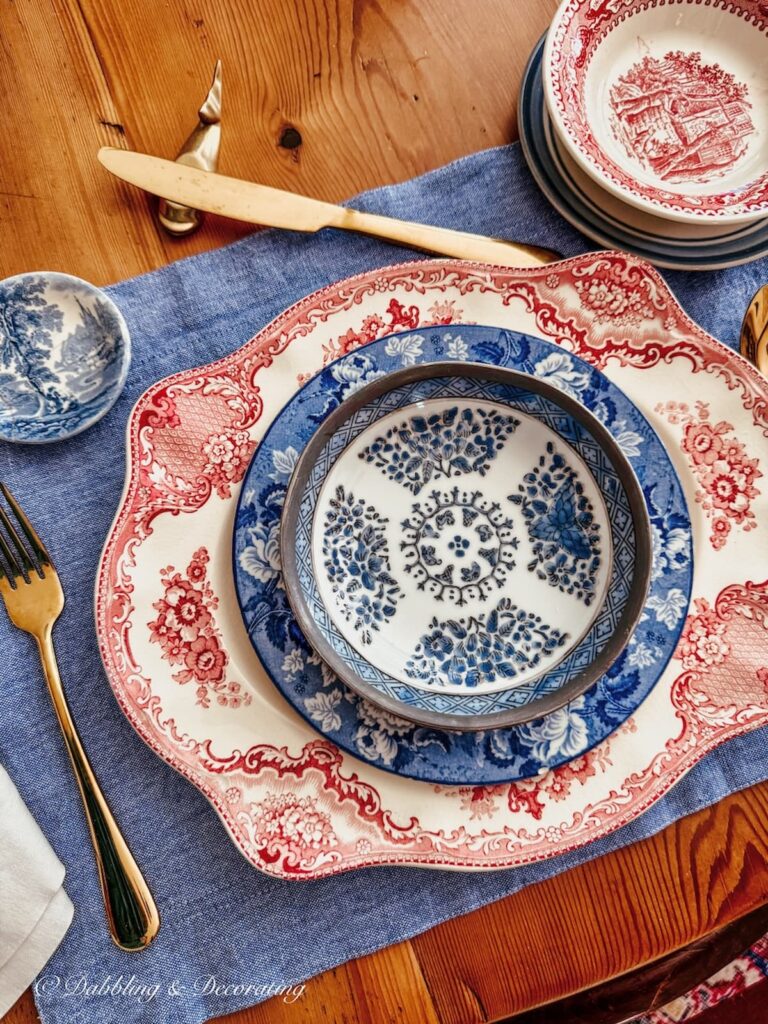 red, white, and blue vintage place setting on denim placemat styled for summer tables.