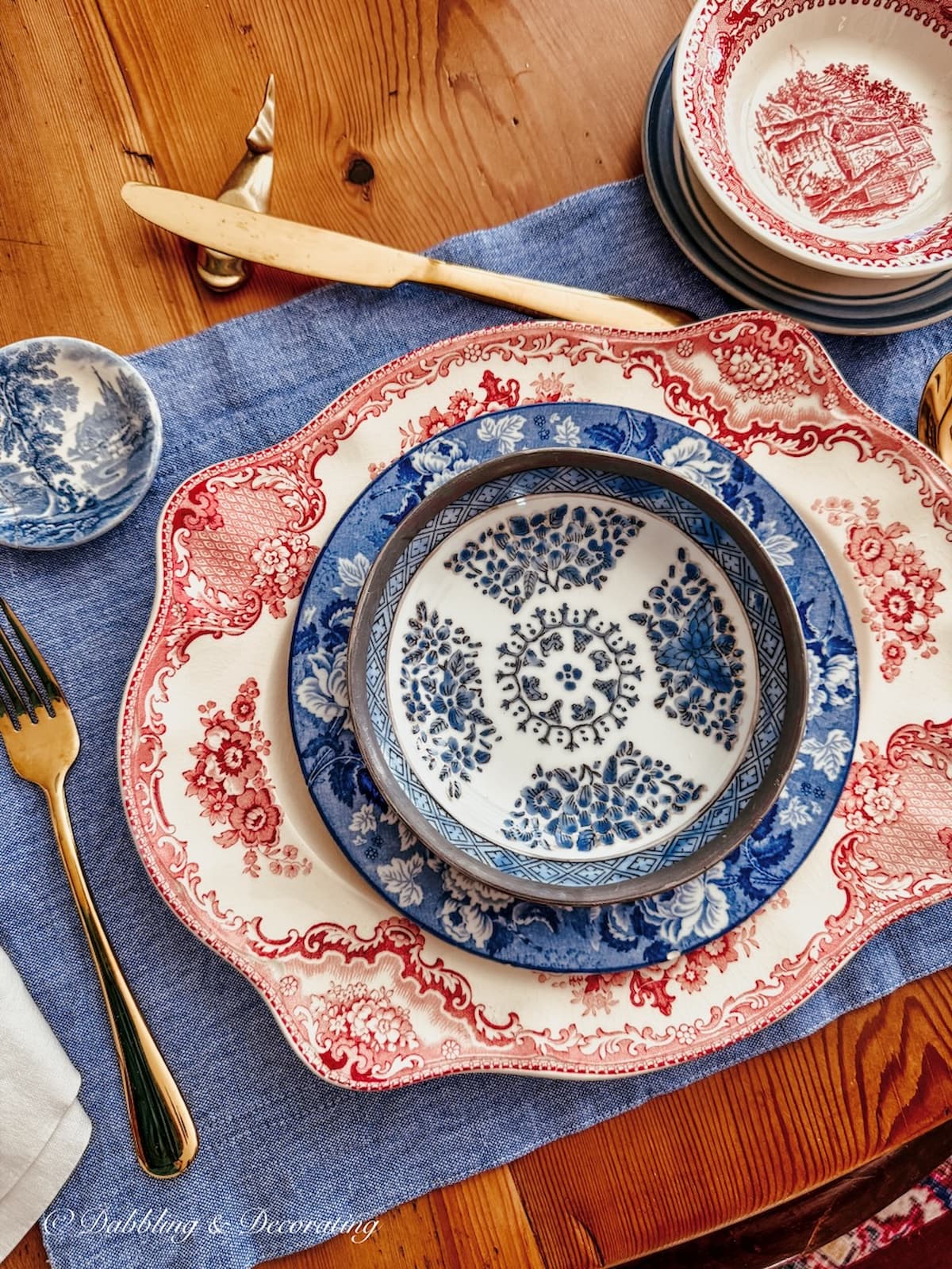 red, white, and blue vintage place setting on denim placemat styled for summer tables.