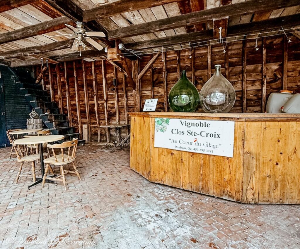 Vignoble Clos Ste-Croix in Dunham, Quebec. Outdoor wine tasting station with demijohn bottles.