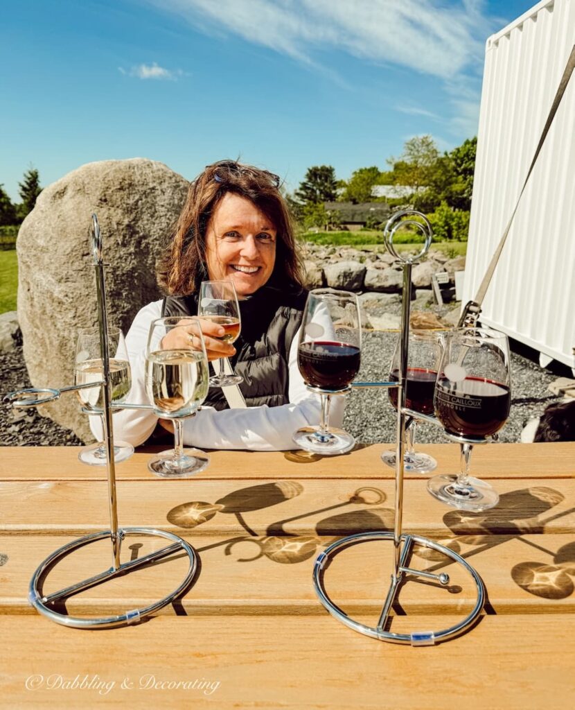 Ann, vintage home decor blogger sipping wine at the Les Petits Cailloux in Eastern Townships, Quebec.